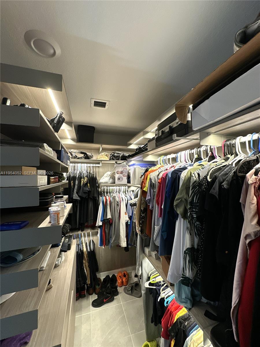 13321 Southwest 284th Street Homestead, FL 33033 - Photo 13 of 30 a view of walk in closet with clothes and shoes