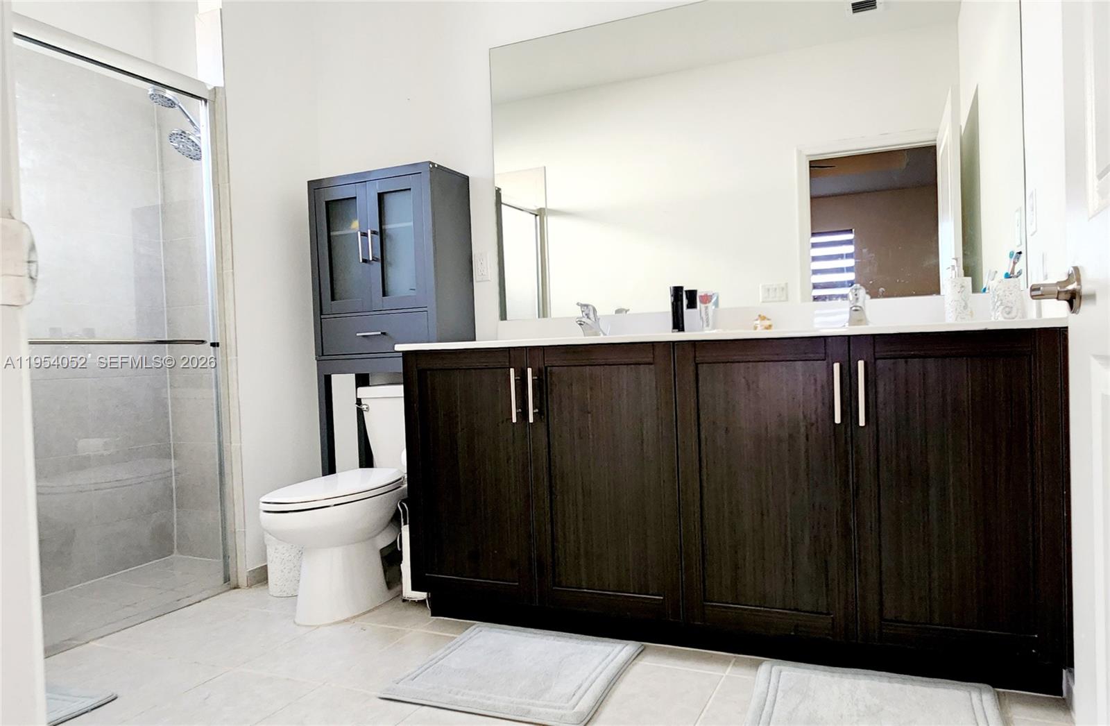 13321 Southwest 284th Street Homestead, FL 33033 - Photo 15 of 30 a bathroom with a sink a toilet and shower