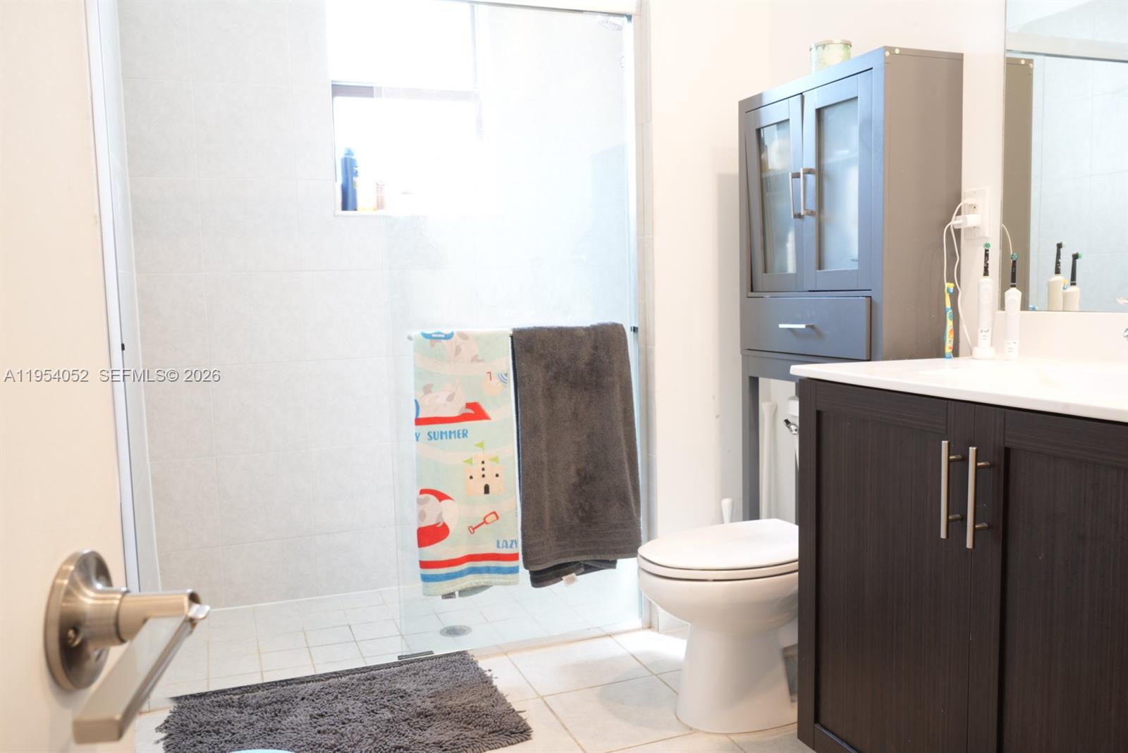 13321 Southwest 284th Street Homestead, FL 33033 - Photo 19 of 30 a bathroom with a sink toilet and shower