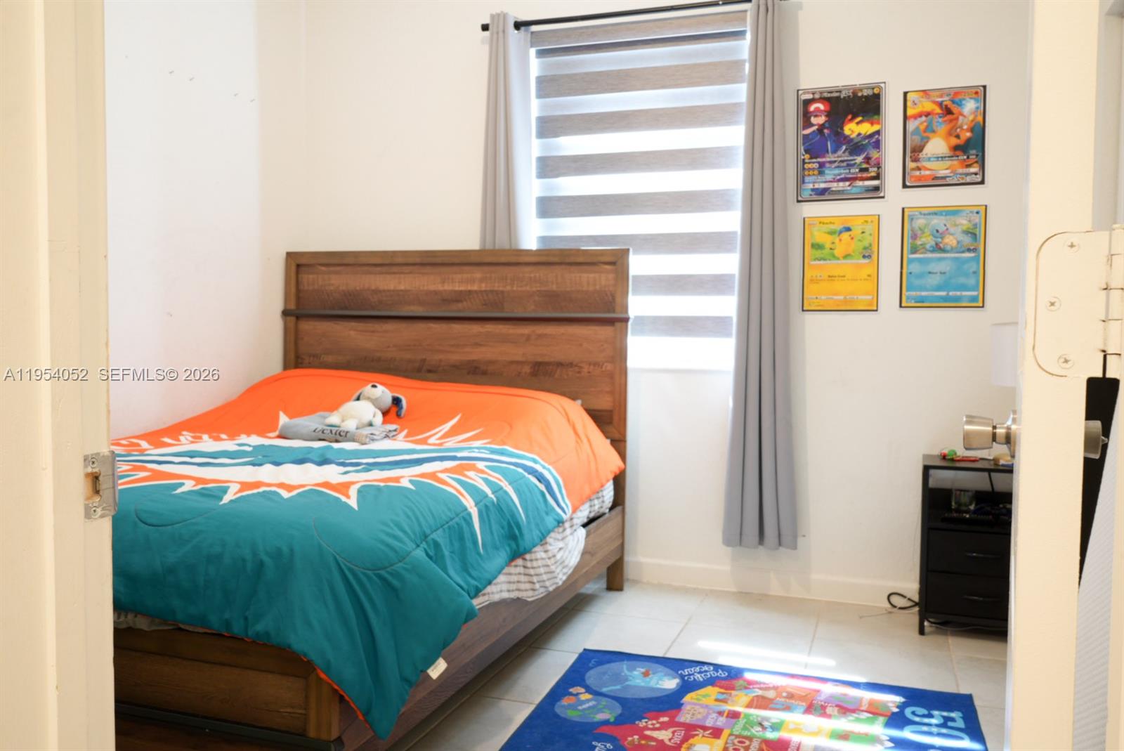 13321 Southwest 284th Street Homestead, FL 33033 - Photo 23 of 30 a bedroom with a bed and a painting on the wall