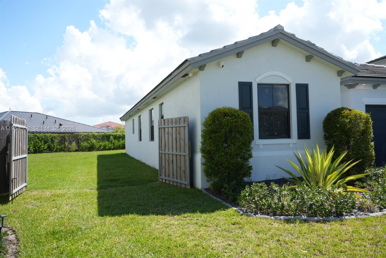 13321 Southwest 284th Street Homestead, FL 33033 - Photo 27 of 30 a front view of a house with garden