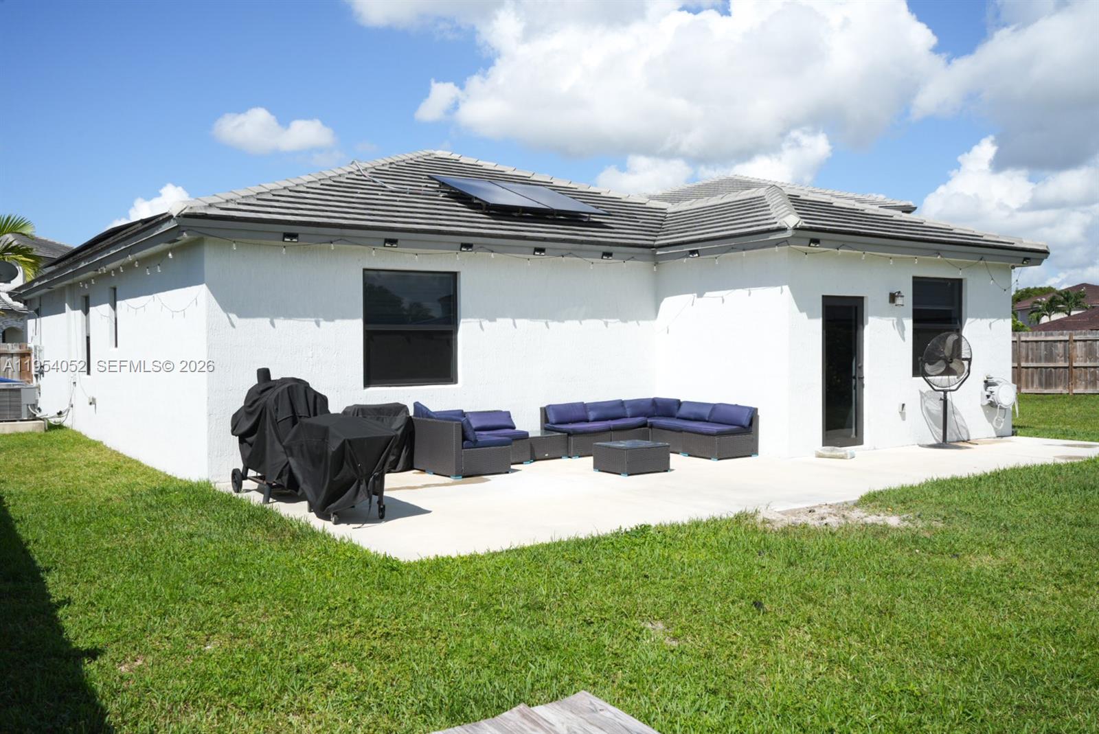 13321 Southwest 284th Street Homestead, FL 33033 - Photo 29 of 30 a view of a porch in front of a house with plants and a large tree