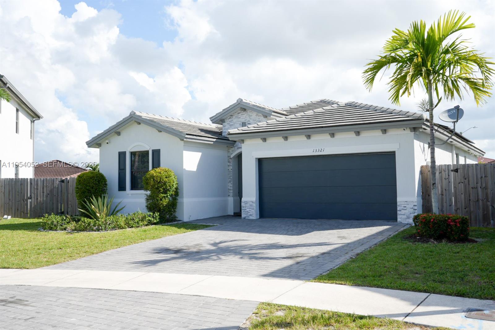 13321 Southwest 284th Street Homestead, FL 33033 - Photo 30 of 30 a front view of a house with a garden and yard