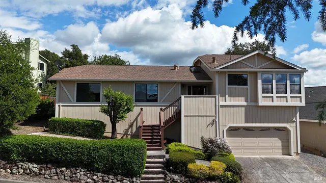 a front view of a house with a garden