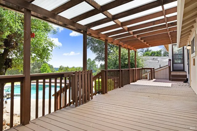 a view of a balcony with wooden floor