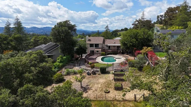 a backyard of a house with table and chairs