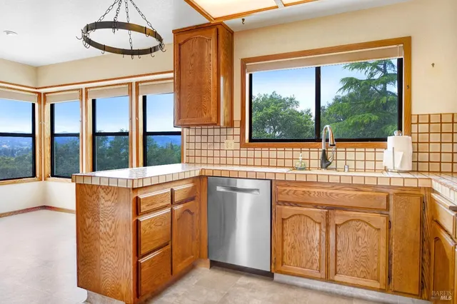 a kitchen with stainless steel appliances granite countertop a stove and a sink