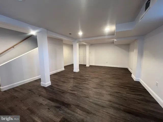 an empty room with wooden floor