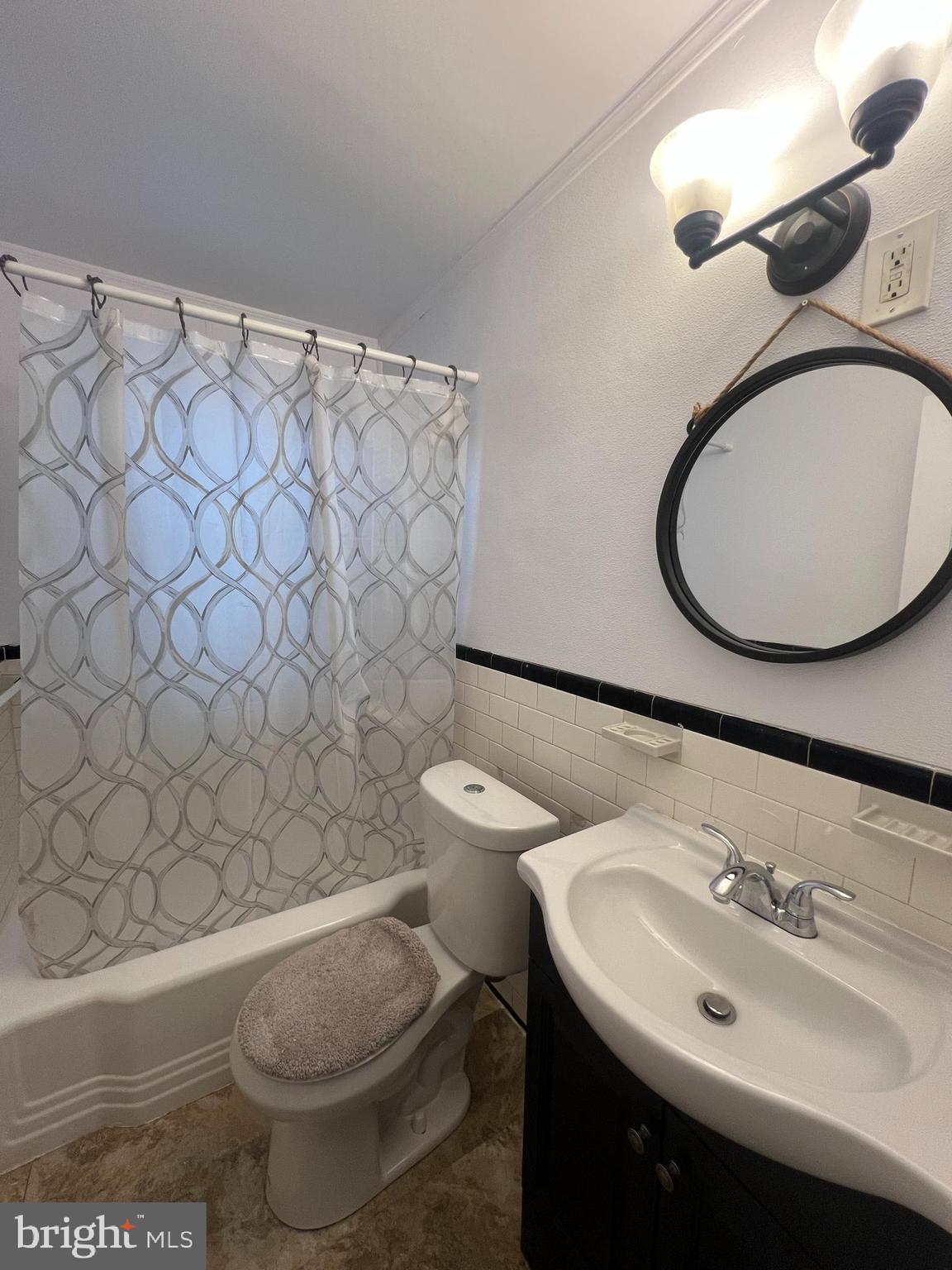 2900 Cornwall Road Baltimore, MD 21222 - Photo 17 of 17 a bathroom with a sink mirror vanity and toilet