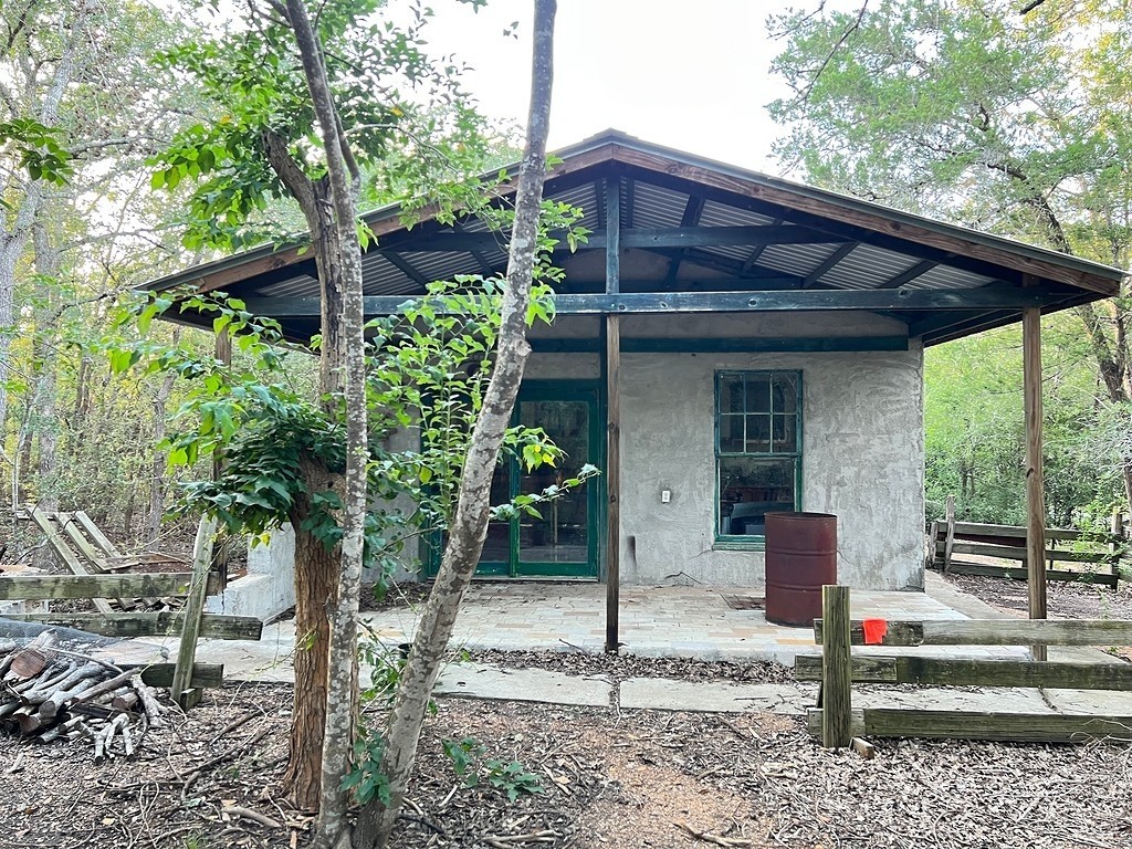 117 Caddo Smithville, TX 78957 - Photo 12 of 19 Rear view of house with stucco siding