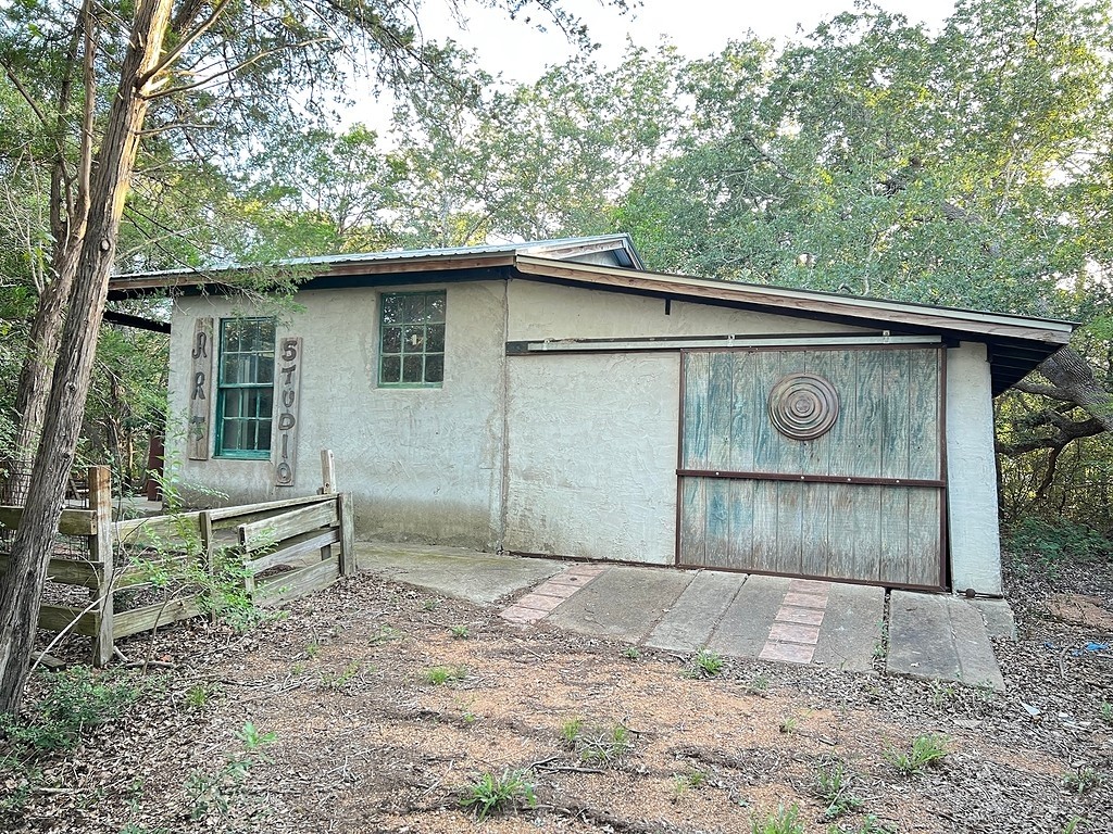117 Caddo Smithville, TX 78957 - Photo 7 of 19 View of property exterior featuring stucco siding