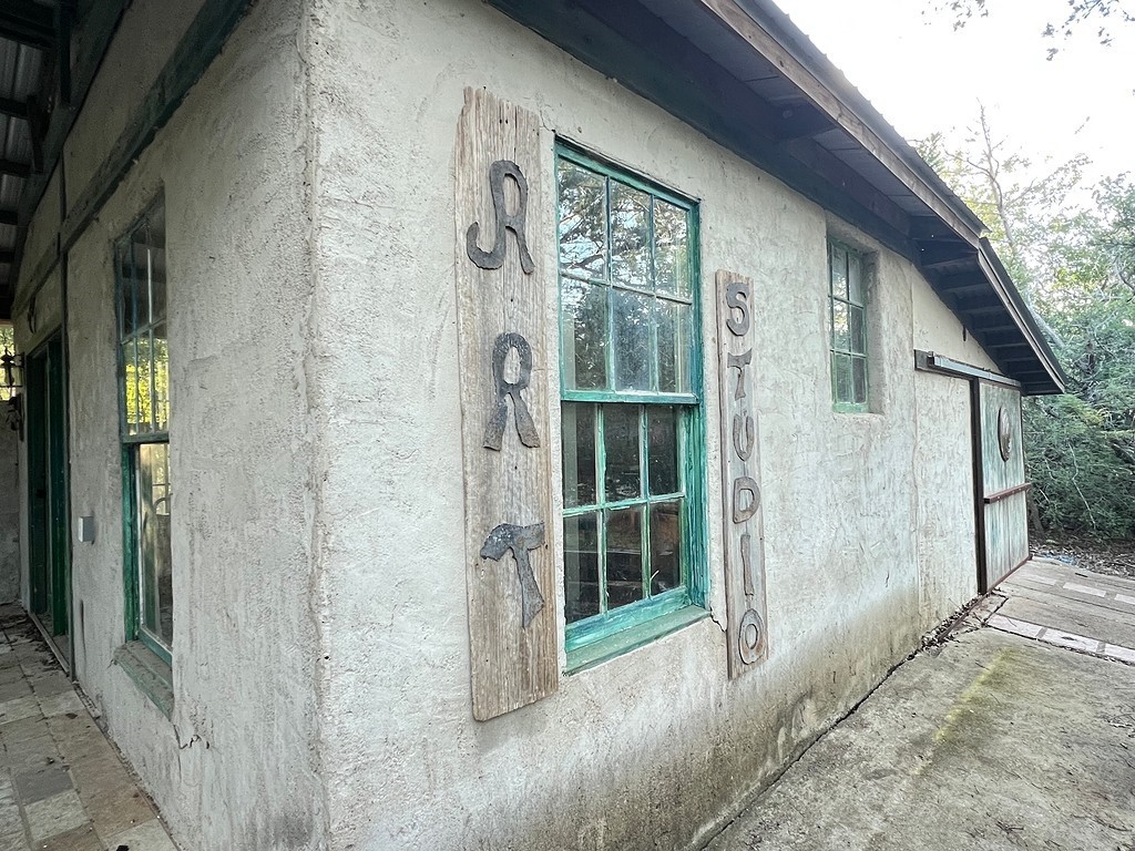 117 Caddo Smithville, TX 78957 - Photo 8 of 19 View of home's exterior with stucco siding