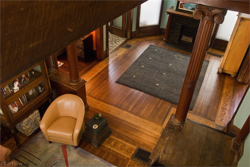 Looking down into great room. Refinished wood flooring.