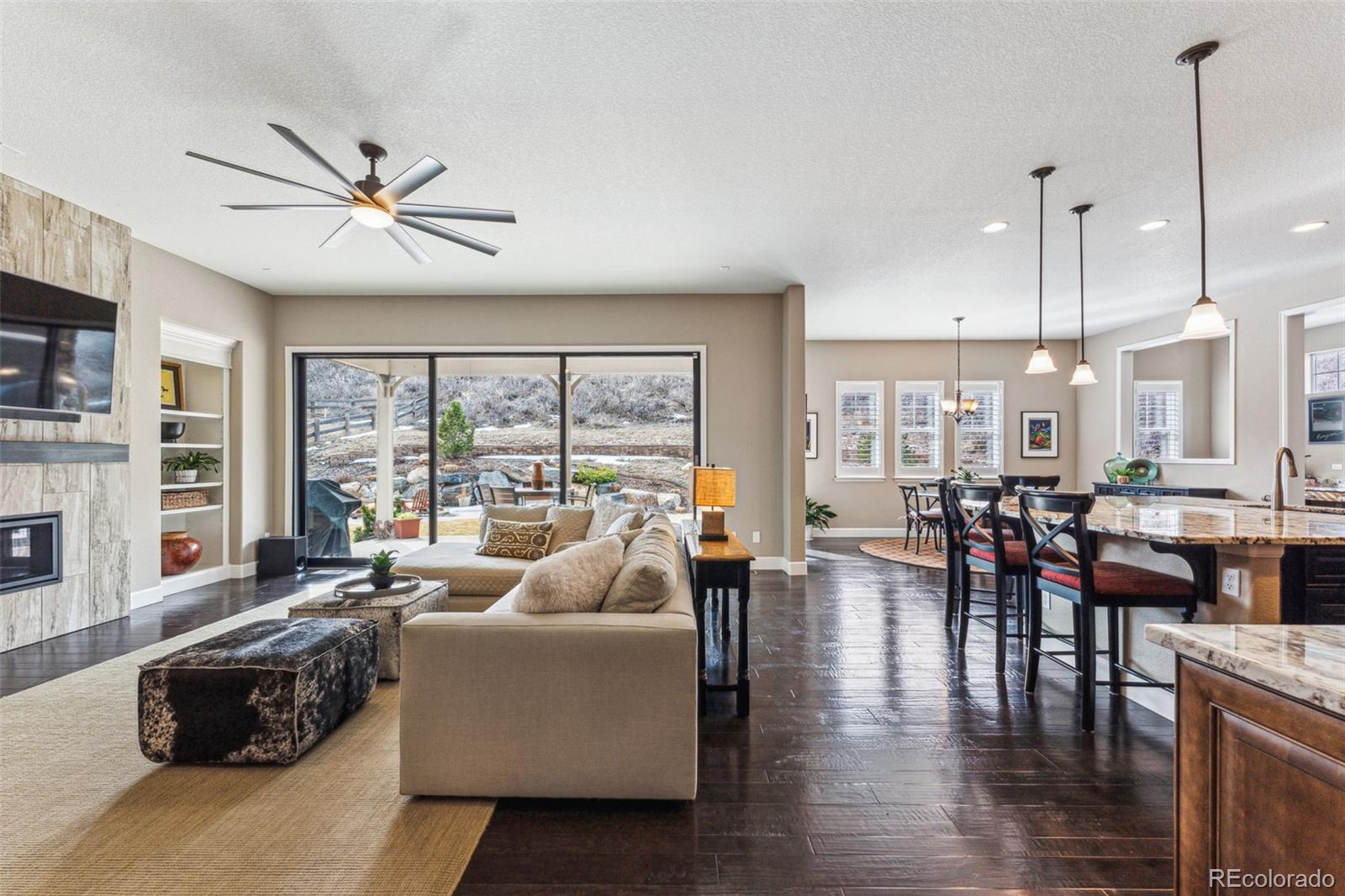 4937 Hogback Ridge Road Morrison, CO 80465 - Photo 11 of 43 a living room with furniture and a large window