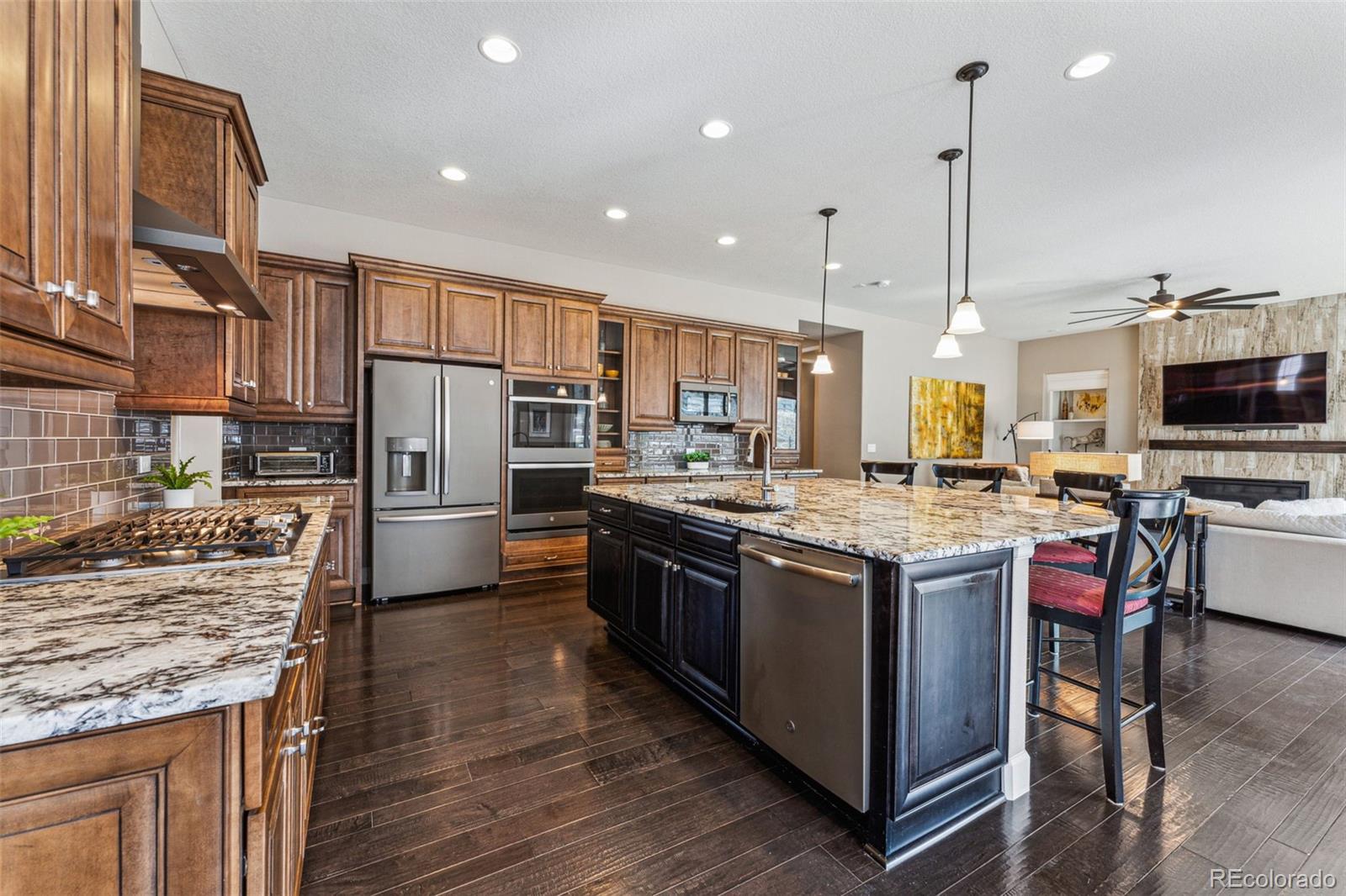 4937 Hogback Ridge Road Morrison, CO 80465 - Photo 13 of 43 a kitchen with stainless steel appliances kitchen island granite countertop a stove and refrigerator