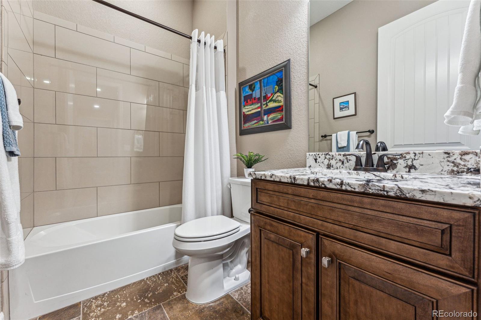 4937 Hogback Ridge Road Morrison, CO 80465 - Photo 17 of 43 a bathroom with a sink a toilet and shower