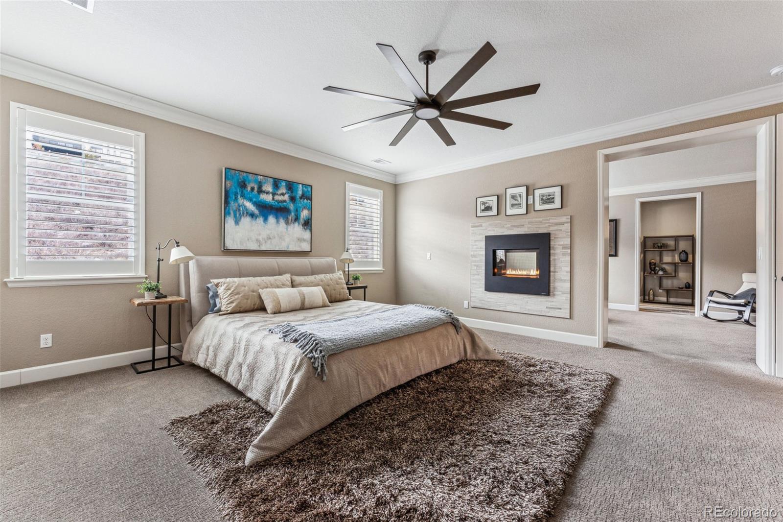 4937 Hogback Ridge Road Morrison, CO 80465 - Photo 18 of 43 a bedroom with a large bed a rug and closet