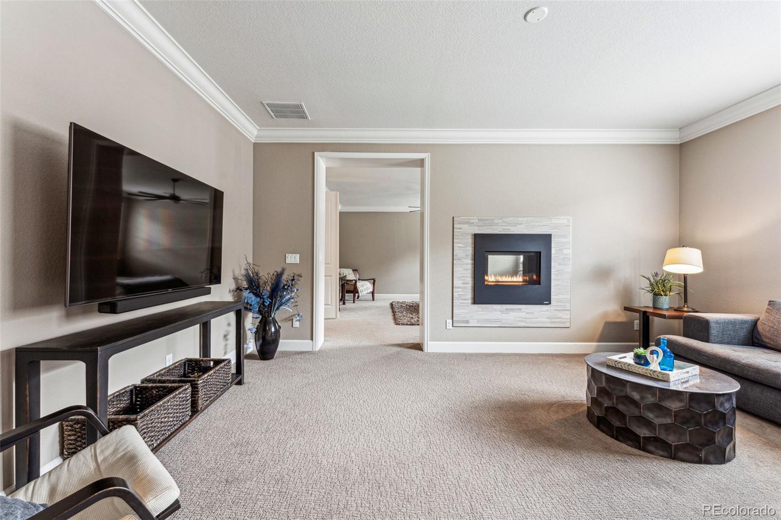 4937 Hogback Ridge Road Morrison, CO 80465 - Photo 20 of 43 a living room with furniture and a flat screen tv