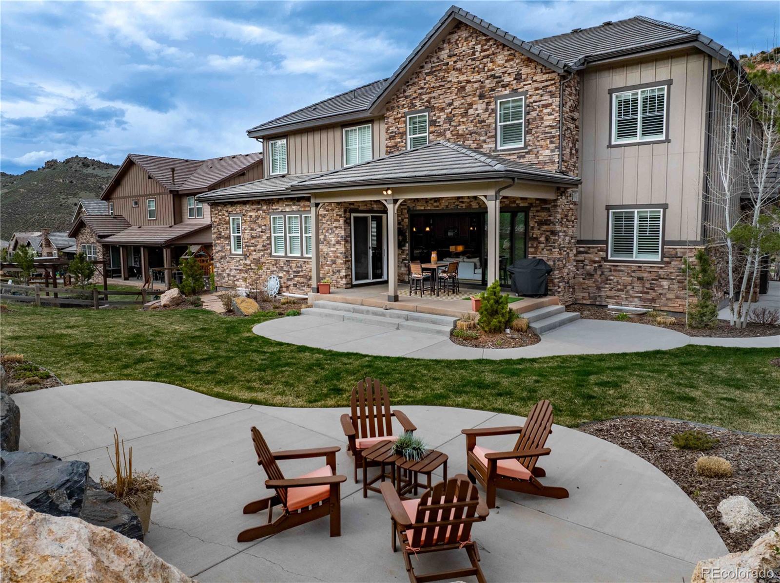 4937 Hogback Ridge Road Morrison, CO 80465 - Photo 2 of 43 a view of a house with backyard sitting area and garden