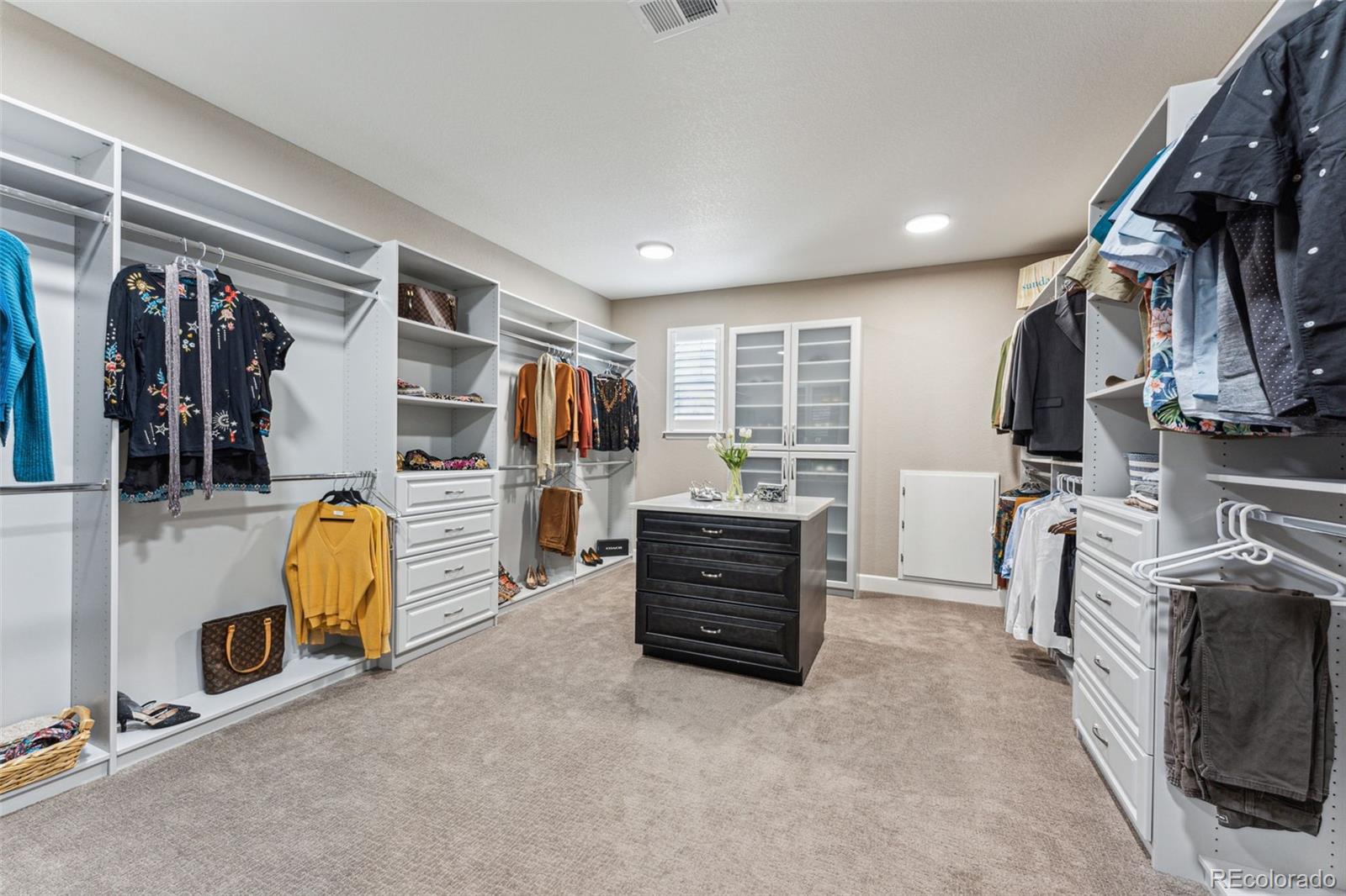 4937 Hogback Ridge Road Morrison, CO 80465 - Photo 21 of 43 a view of walk in closet with clothes and shoes