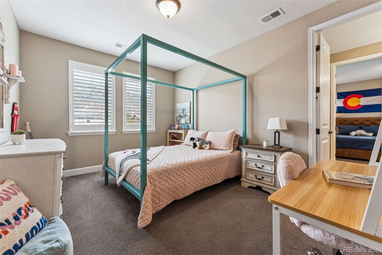 4937 Hogback Ridge Road Morrison, CO 80465 - Photo 25 of 43 a bed room with a bed and a couch