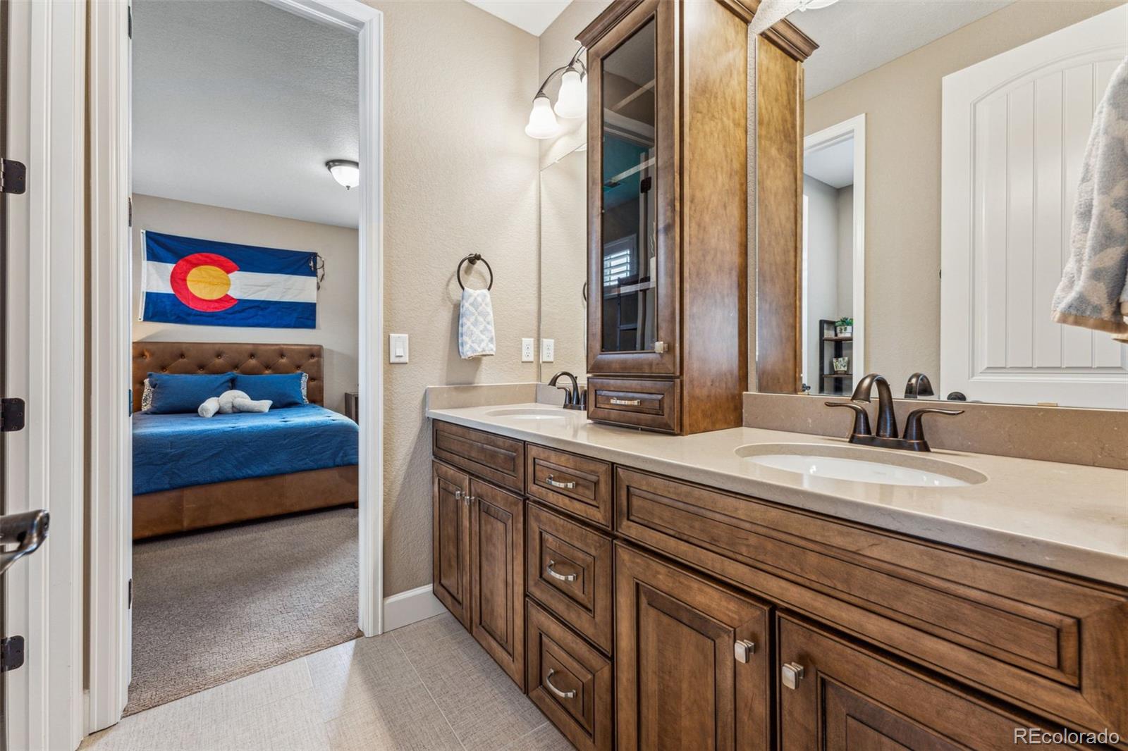 4937 Hogback Ridge Road Morrison, CO 80465 - Photo 26 of 43 a en suite bathroom with a sink and a mirror