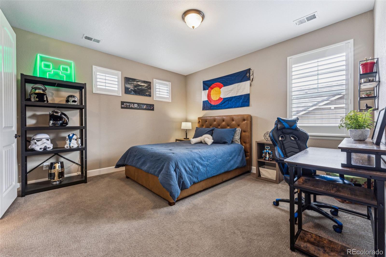 4937 Hogback Ridge Road Morrison, CO 80465 - Photo 27 of 43 a bedroom with a bed and a desk