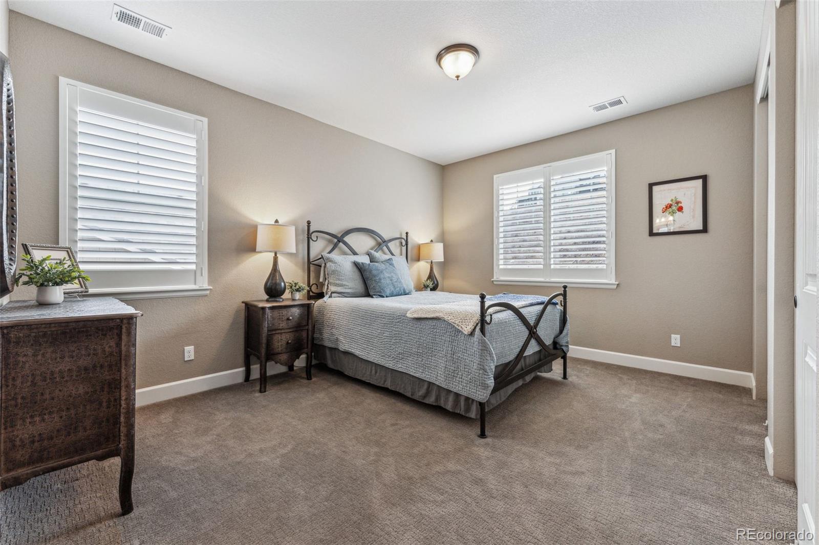 4937 Hogback Ridge Road Morrison, CO 80465 - Photo 28 of 43 a bedroom with a bed and a couch