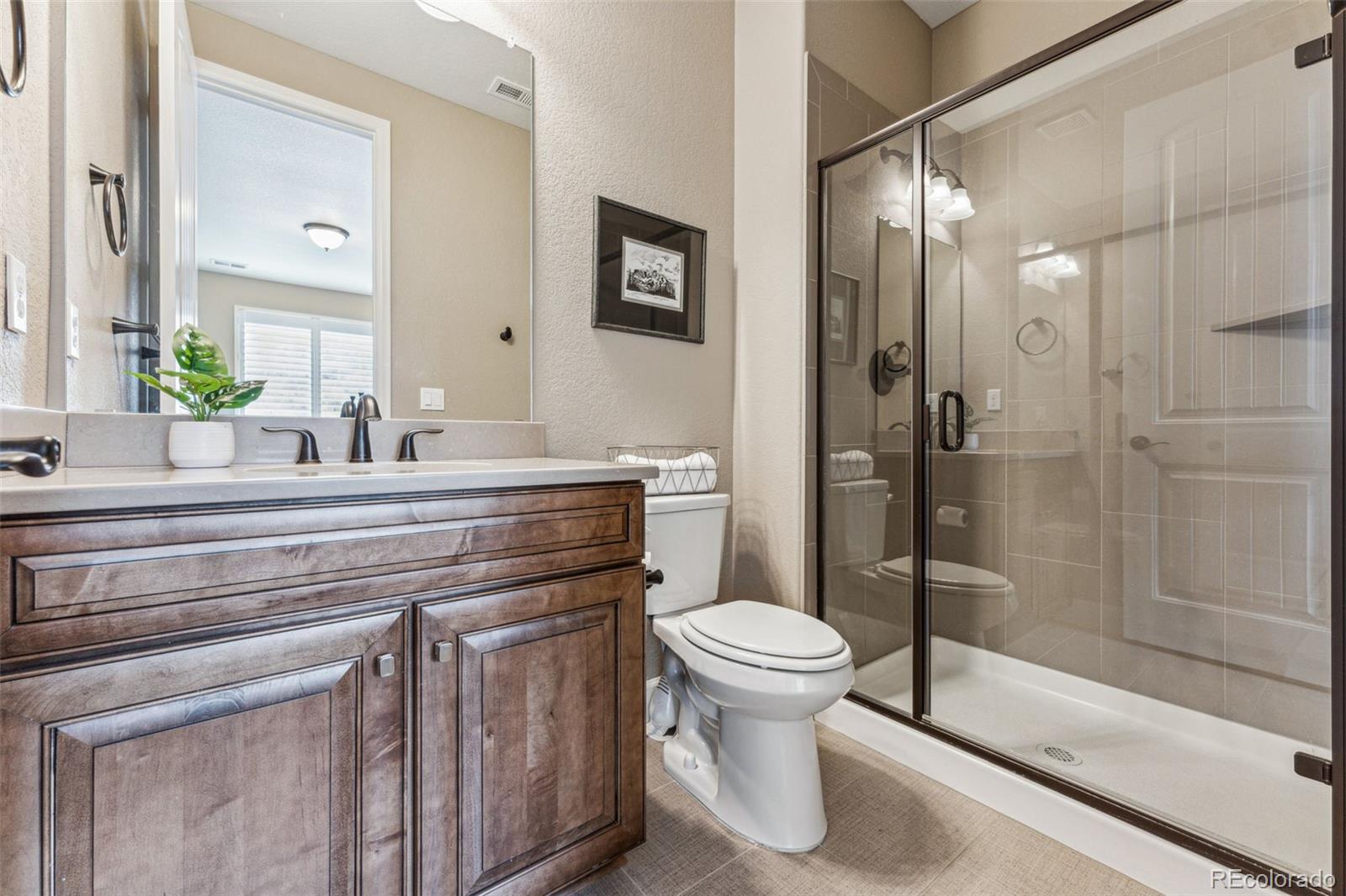 4937 Hogback Ridge Road Morrison, CO 80465 - Photo 29 of 43 a bathroom with a sink toilet and shower