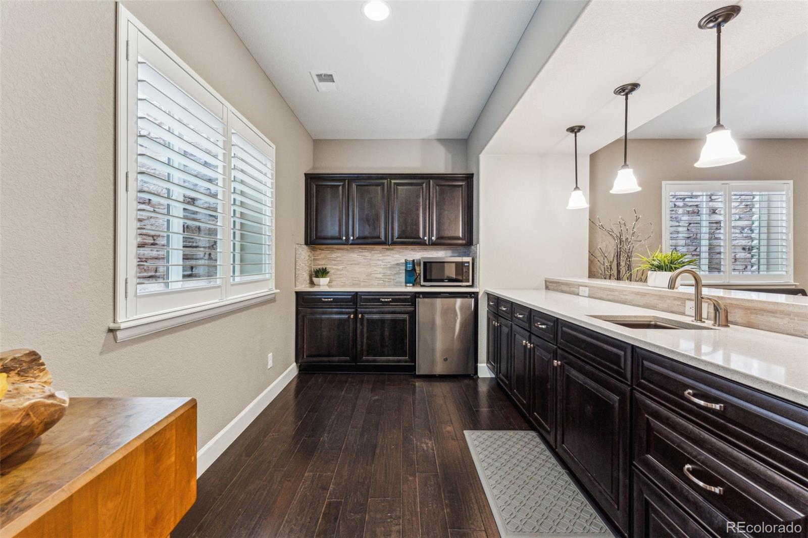 4937 Hogback Ridge Road Morrison, CO 80465 - Photo 33 of 43 a kitchen with stainless steel appliances sink stove and wooden floor