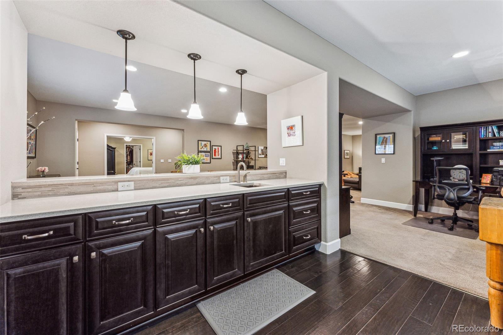 4937 Hogback Ridge Road Morrison, CO 80465 - Photo 34 of 43 a spacious kitchen with stainless steel appliances granite countertop a sink counter space and wooden floor