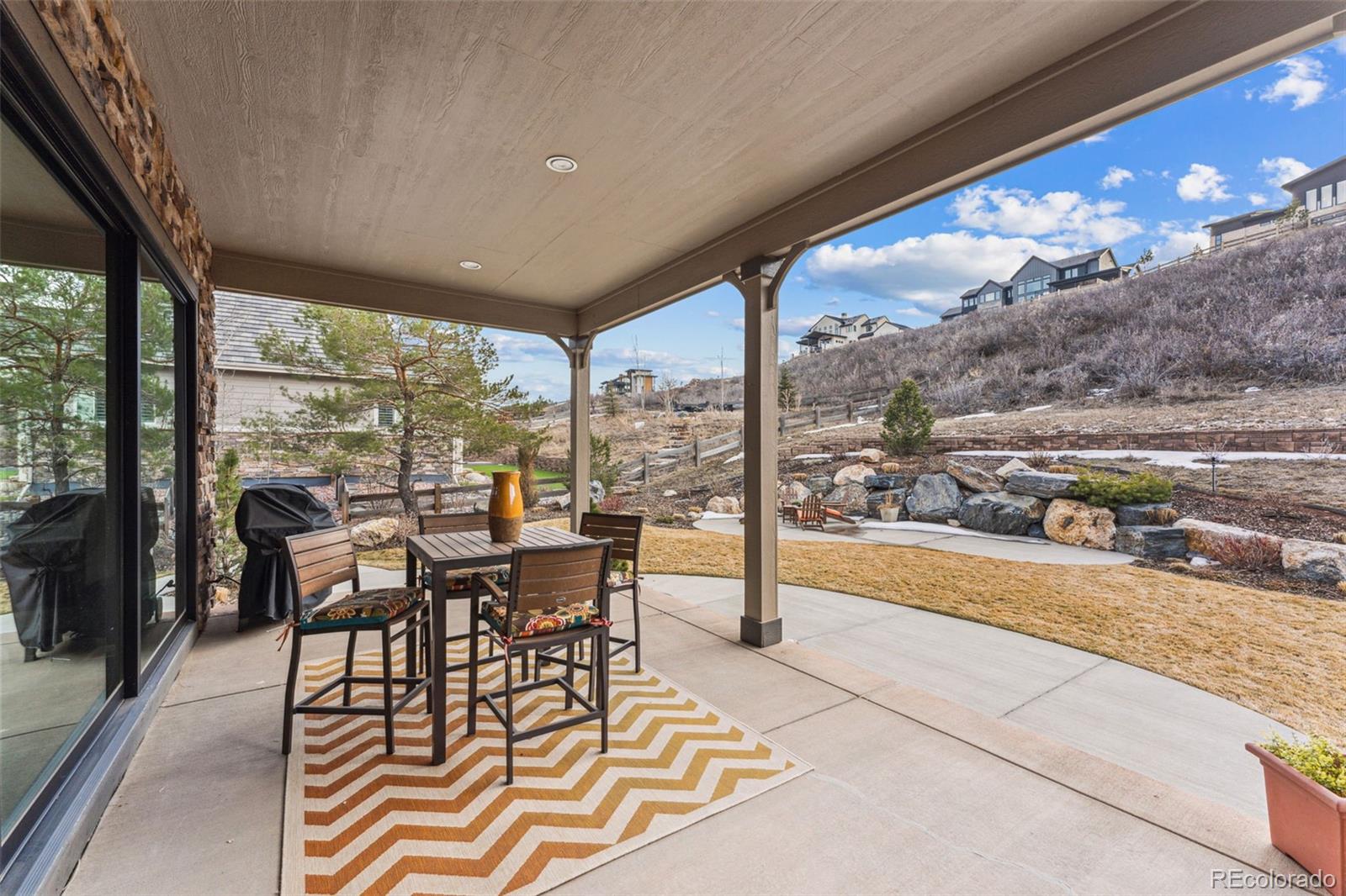 4937 Hogback Ridge Road Morrison, CO 80465 - Photo 41 of 43 a view of a dining room with furniture large windows and wooden floor