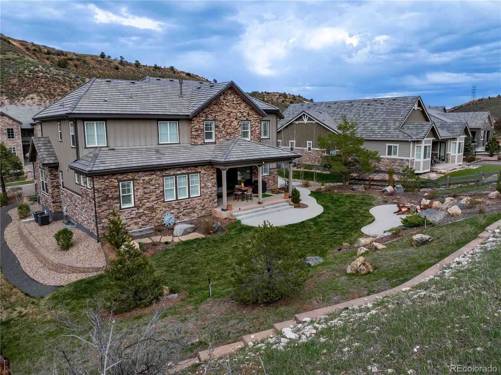 4937 Hogback Ridge Road Morrison, CO 80465 - Photo 42 of 43 a view of a big house with a big yard and potted plants
