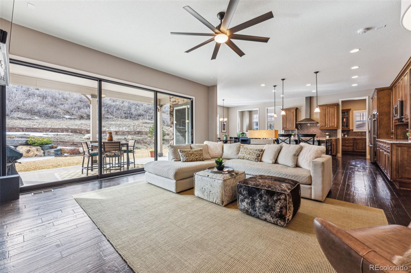 4937 Hogback Ridge Road Morrison, CO 80465 - Photo 8 of 43 a living room with furniture and a large window with kitchen view