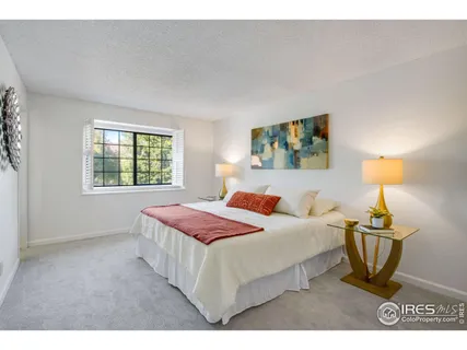 a bedroom with a bed and a lamp