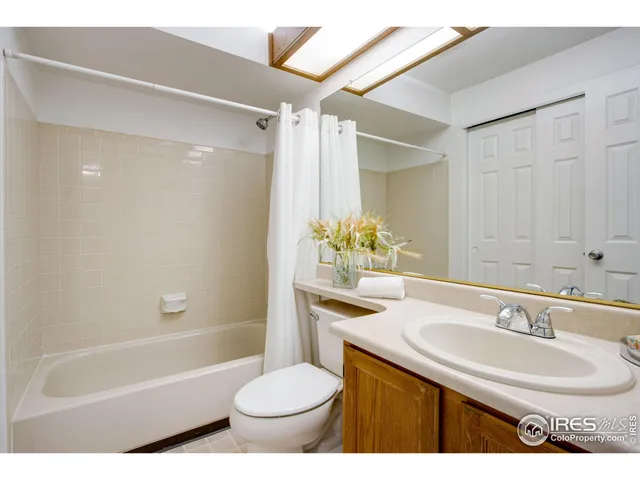 a bathroom with a sink toilet a mirror and shower