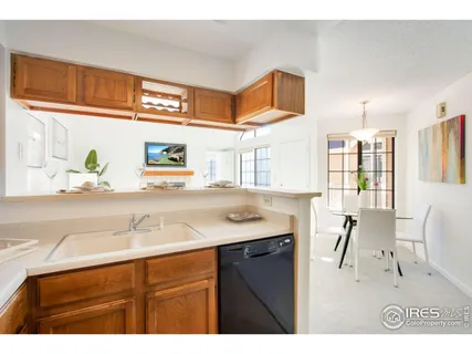 a kitchen with a sink cabinets and window