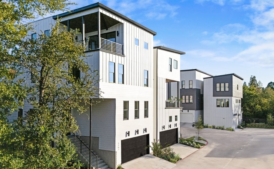 5001 Childers Path Austin, TX 78741 - Photo 6 of 40 View of building exterior featuring a garage and concrete driveway