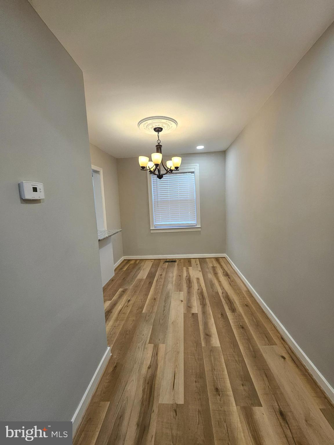4546 Mountview Road Baltimore, MD 21229 - Photo 11 of 45 a view of a room with wooden floor and chandelier