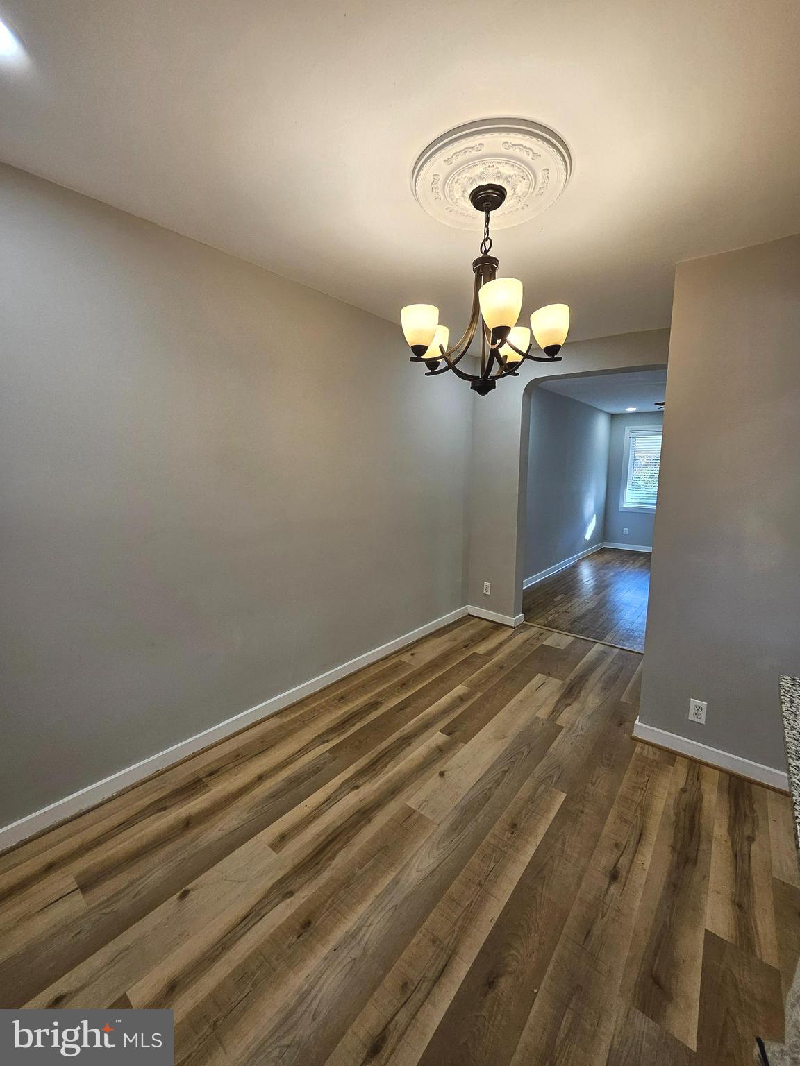 4546 Mountview Road Baltimore, MD 21229 - Photo 13 of 45 a view of a chandelier fan and wooden floor