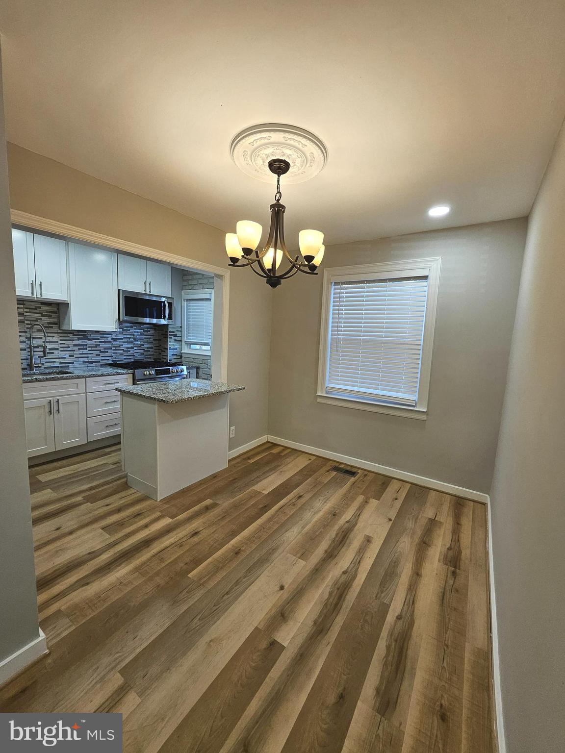 4546 Mountview Road Baltimore, MD 21229 - Photo 14 of 45 a view of a kitchen sink and dishwasher with wooden floor