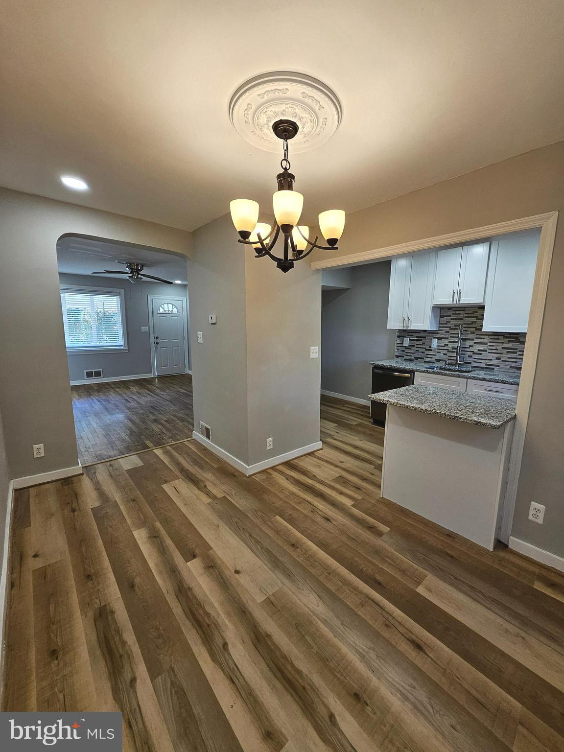 4546 Mountview Road Baltimore, MD 21229 - Photo 16 of 45 a bedroom with a bed and a chandelier