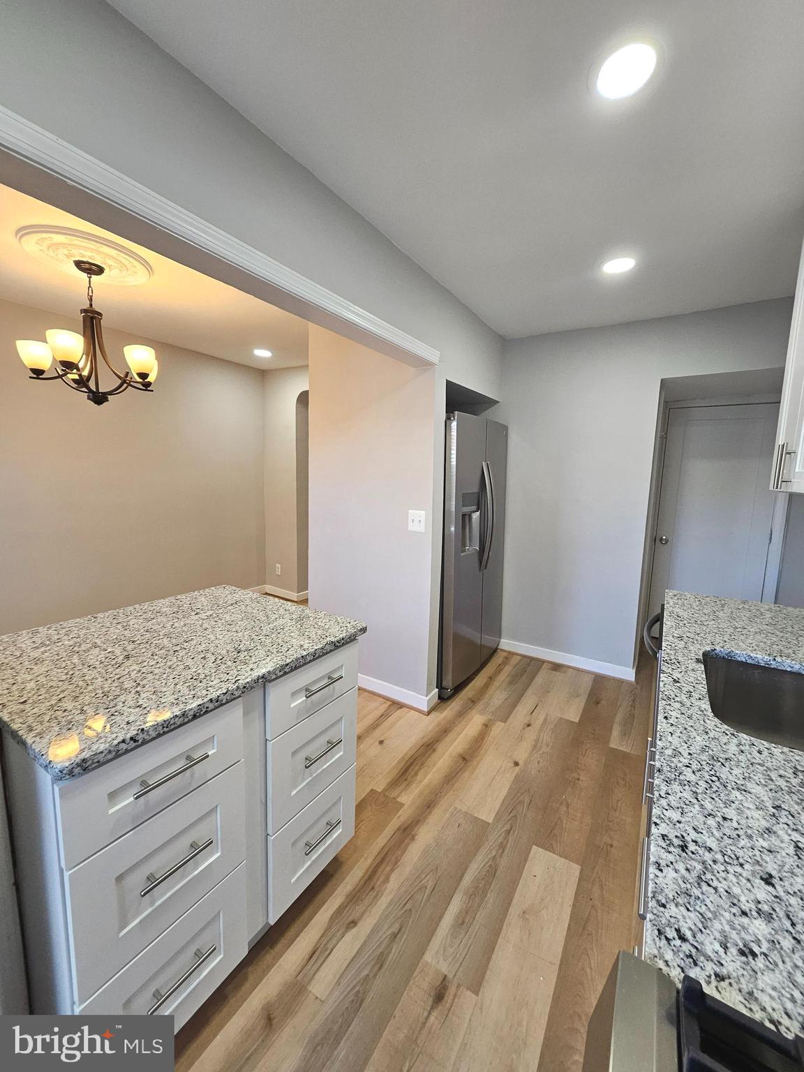 4546 Mountview Road Baltimore, MD 21229 - Photo 22 of 45 a bathroom with a granite countertop sink and a mirror