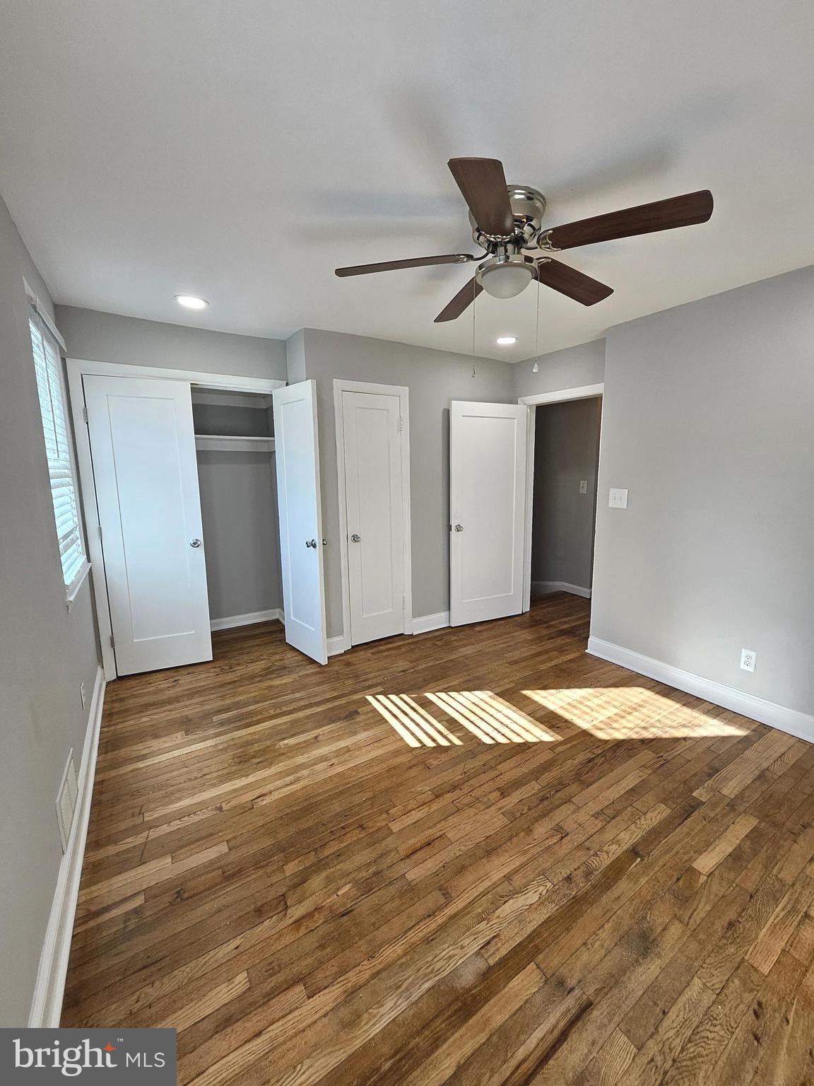 4546 Mountview Road Baltimore, MD 21229 - Photo 26 of 45 a view of empty room with wooden floor and ceiling fan