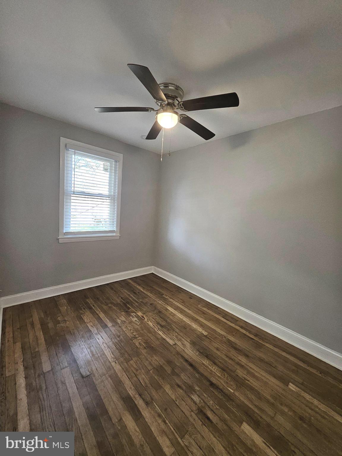 4546 Mountview Road Baltimore, MD 21229 - Photo 27 of 45 a view of an empty room with wooden floor and a window