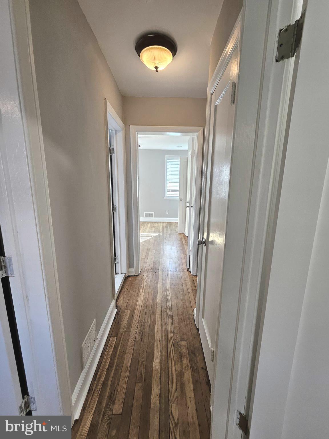 4546 Mountview Road Baltimore, MD 21229 - Photo 29 of 45 a view of a hallway with wooden floor