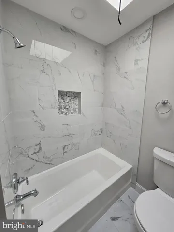 a bathroom with a bathtub and a toilet