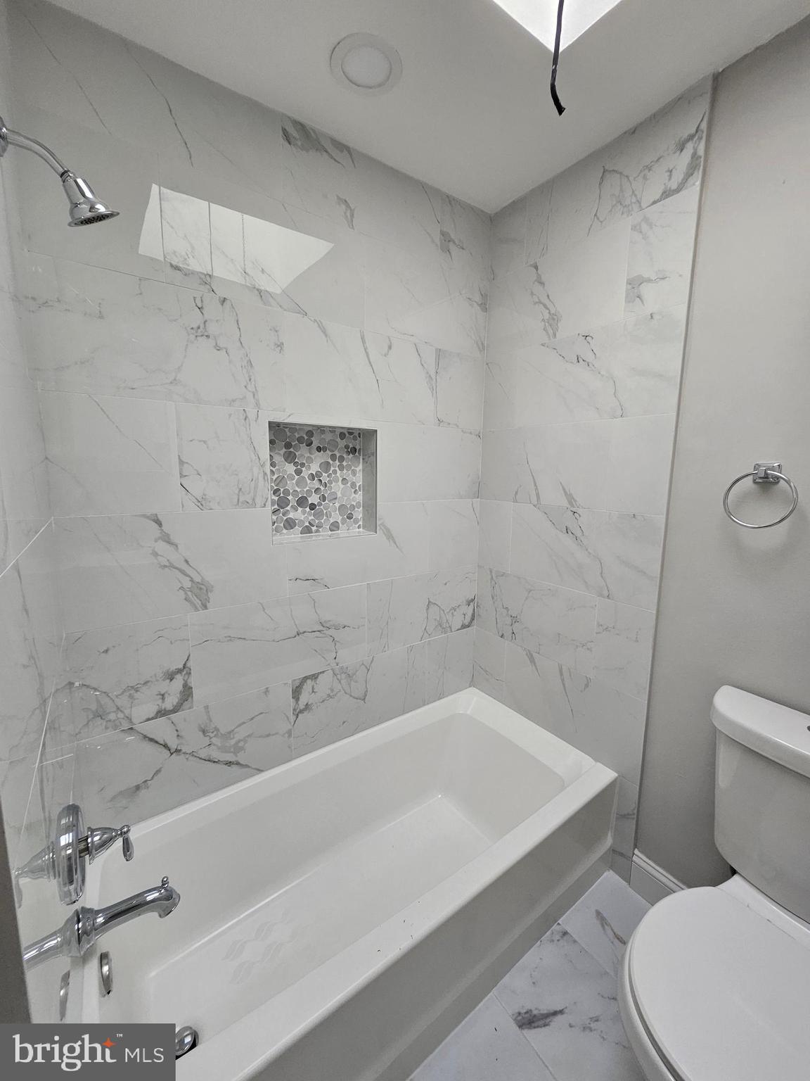4546 Mountview Road Baltimore, MD 21229 - Photo 30 of 45 a bathroom with a bathtub and a toilet