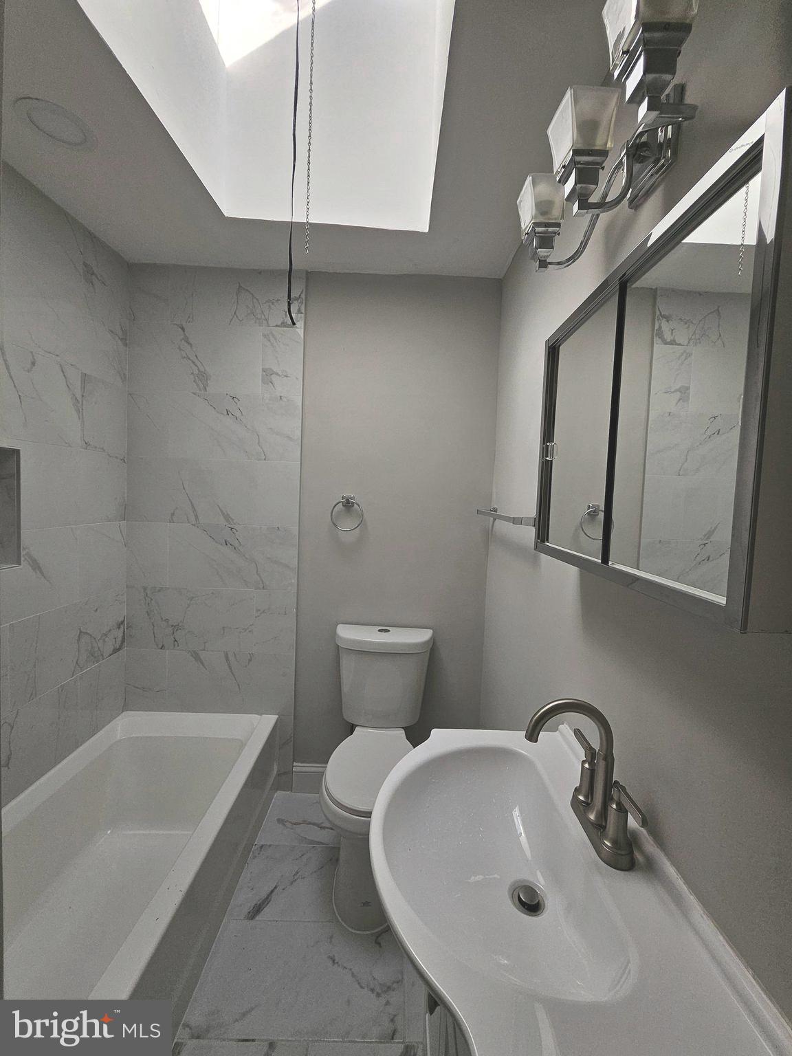 4546 Mountview Road Baltimore, MD 21229 - Photo 32 of 45 a bathroom with a sink a toilet and bathtub