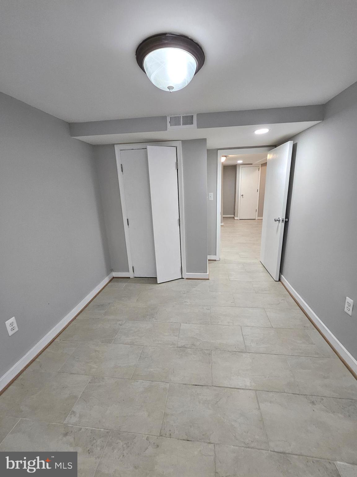 4546 Mountview Road Baltimore, MD 21229 - Photo 37 of 45 an empty room with a space and a ceiling fan